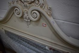 A modern cream frame Rococo style wall mirror