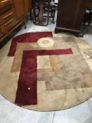 A modern circular rug, in beige and burgundy, diameter approx. 175cm