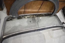 A spare windscreen for MGB Midget