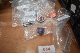 A selection of motor and petrol related pin and enamel badges