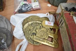 A selection of brass steam rally badges