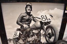 A black and white photographic print of a motorcycle rider