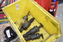A set of four brass and glass fuel filters