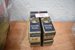 A set of four Champion J12 spark plugs