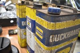 Three Duckhams oil cans