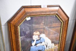 A framed print of a girl sat with dog