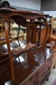 An early 20thb Century mahogany occasional table having shaped legs and undertier