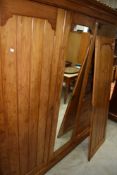 A Victorian Aesthetic style pine triple wardrobe, having central mirror