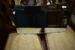 A vintage frameless wall mirror