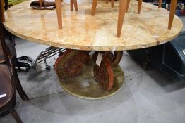 A large circular table having octopus style base with velvet lining