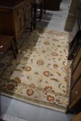 A modern carpet square in the traditional style, cream ground approx. 230 x 160cm
