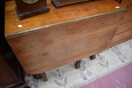 A mid 20th Century drop leaf dining table