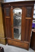 A Victorian mahogany mirror door single wardrobe, width approx. 108cm. On drawer base