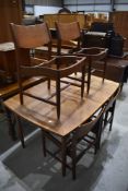 A vintage teak extending dining table and set of four chair frames (seats removed)