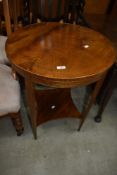 An Edwardian circular occasional table having shaped undertier