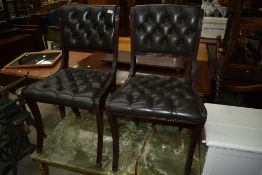 A pair of reproduction Regency style office or dining chairs having buttoned leather upholstery