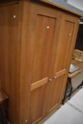 A modern golden oak wardrobe, dimensions approx W117cm H193cm D60cm, looks good quality