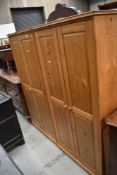 A pair of natural pine small wardrobes