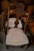 A pair of early 20th Century mahogany dining chairs having carved back , upholstered seats and