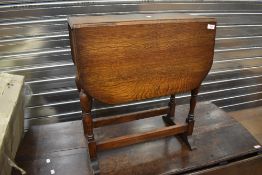 A traditional oak drop leaf table having twist top, width approx. 60cm