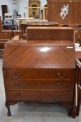 A mid 20th Century mahogany bureau on cabriole legs