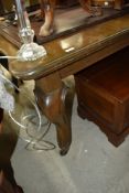 An extendable dining room table on cabriole legs