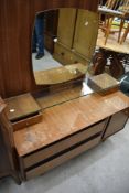 A mid 20th Century vintage low dressing table, of stylised design, in need of some tidying up, width