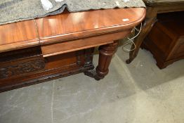 A Victorian wind out mahogany dining table on carved legs