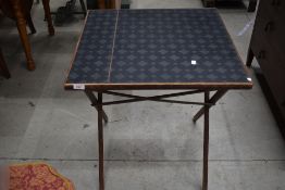 A traditional folding card table, signs of worm to corner
