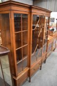 An impressive light mahogany breakfront display cabinet, labelled Waring and Gillows with brass lock