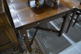 An early 20th Century oak drawer leaf dining table on barley twist frame, closed approx. 90 x 90cm