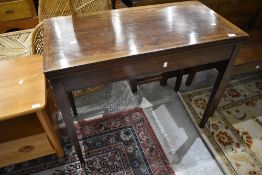 An early 20th Century fold over card table, in need of restoration, no inset to top