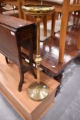 A vintage brass smokers stand