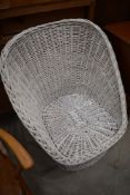 A wicker painted tub style chair