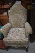 An early 20th Century wingback armchair