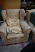A pair of traditional wing back armchairs