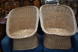 A pair of wicker tub style chairs