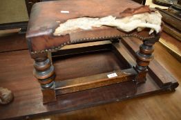 A traditional footstool in the refectory style with overstuffed seat (af)