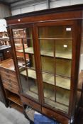 An early 20th Century mahogany display cabinet having two drawer under , on tapered legs and spade