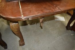 An extendable mahogany dining table