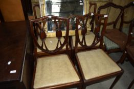 A set of four reproduction dining chairs