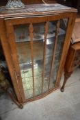 A mid 20th Century walnut china cabinet