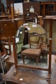 An early 20th Century frameless toilet mirror on oak supports