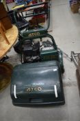 A vintage petrol ride on lawnmower by Atco having Briggs and Stratton engine