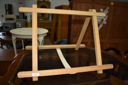 A vintage table easel labelled EJ Arnold
