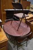 A vintage folding metal circular table and set of three similar chairs, labelled Cosco, with vinyl