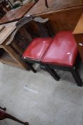 A late 19th or early 20th Century carved oak corner chair and similar stool, with red leather