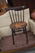 An early 20th Century spindle back kitchen or dining chair having 'H' stretcher