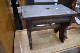 A traditional dark stained pine stool