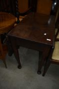 A Victorian drop leaf mahogany dining table